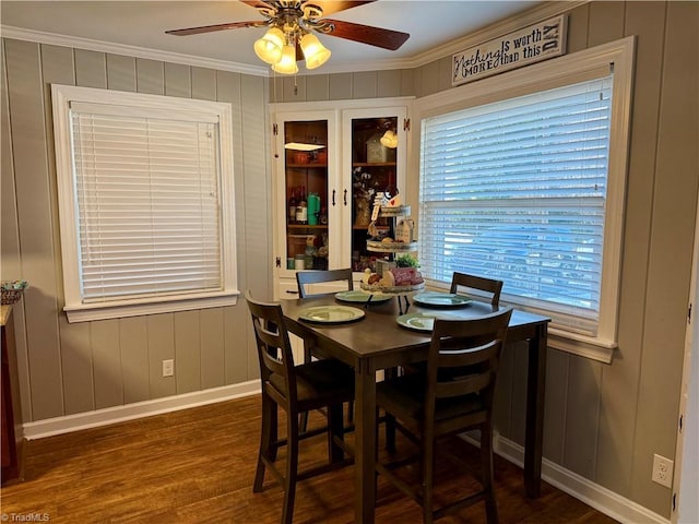 dining room featuring ceiling fan, crown molding, and dark hardwood / wood-style flooring