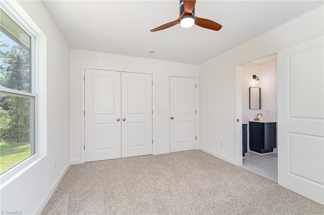 4000 Groometown Rd, Greensboro, NC 27407 - unfurnished bedroom featuring light colored carpet, multiple windows, a closet, and connected bathroom
