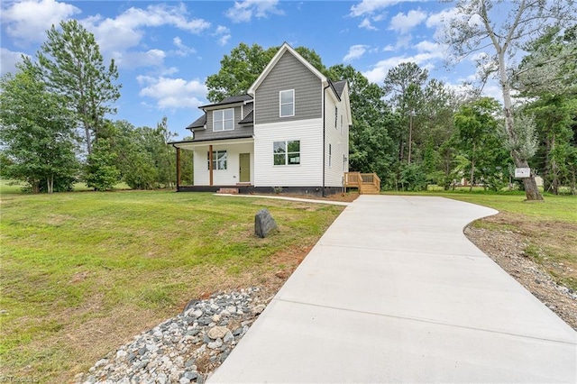 4000 Groometown Rd, Greensboro, NC 27407 - view of front of property with driveway, a front yard, and a porch