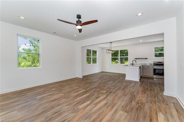 4000 Groometown Rd, Greensboro, NC 27407 - unfurnished living room featuring wood finished floors, recessed lighting, and a ceiling fan
