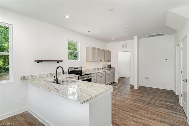 4000 Groometown Rd, Greensboro, NC 27407 - kitchen with appliances with stainless steel finishes, healthy amount of natural light, light stone countertops, dark wood finished floors, and recessed lighting