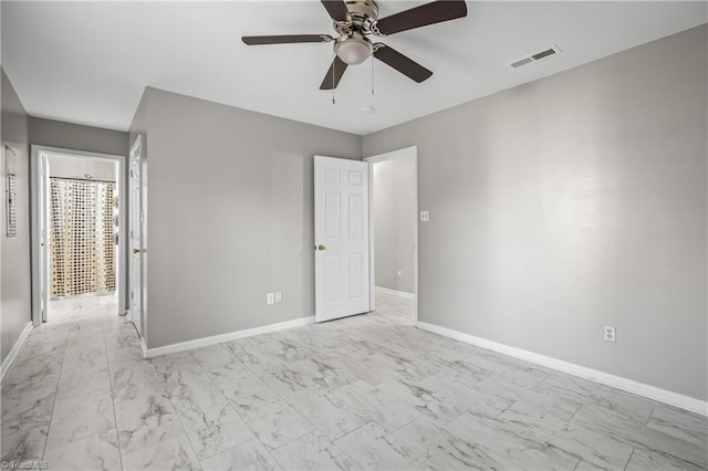 unfurnished bedroom featuring marble finish floor, baseboards, visible vents, and ceiling fan