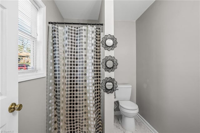 bathroom with toilet, marble finish floor, a shower with curtain, and baseboards