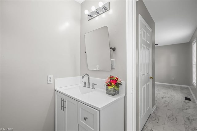 bathroom featuring marble finish floor, visible vents, vanity, and baseboards