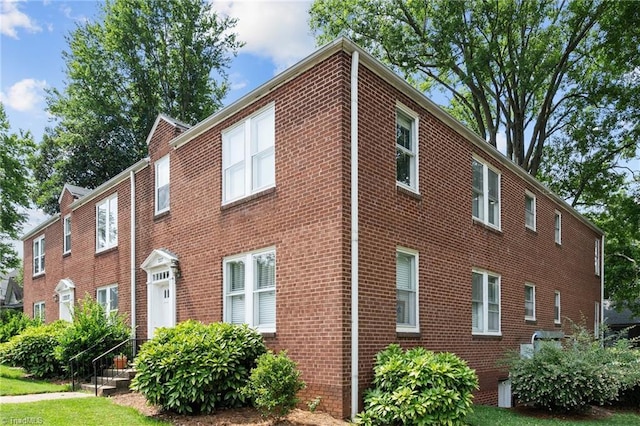 view of property exterior featuring brick siding