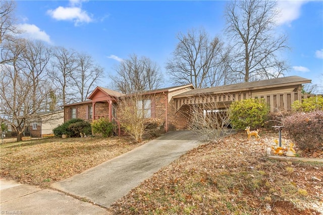 single story home with concrete driveway and brick siding