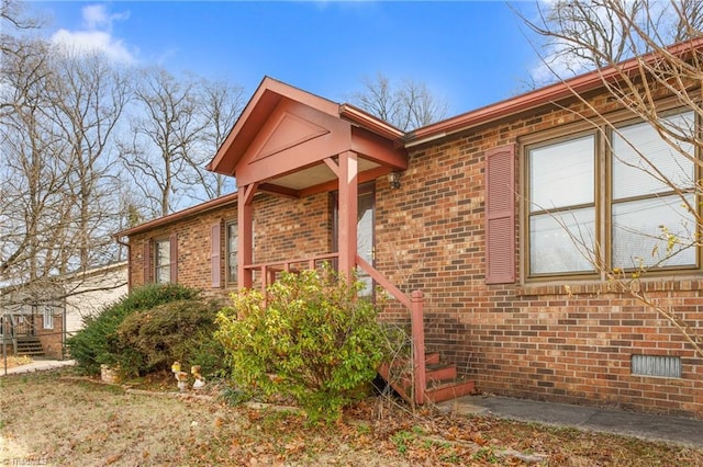 exterior space with brick siding and crawl space