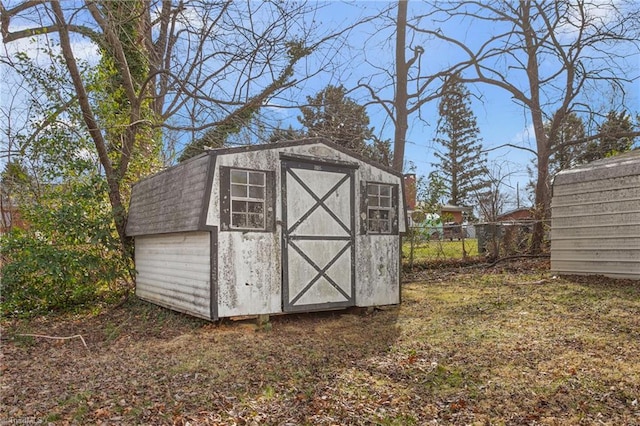 view of shed featuring fence