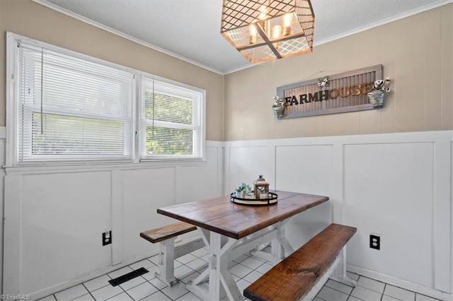 dining space featuring crown molding