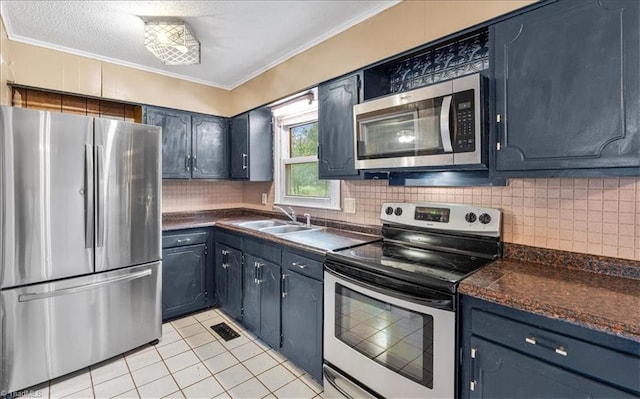 kitchen featuring stainless steel appliances, decorative backsplash, sink, light tile patterned floors, and ornamental molding