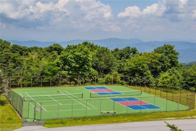 view of tennis court with a mountain view