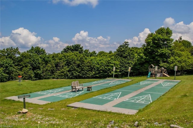 view of home's community featuring a playground and a lawn