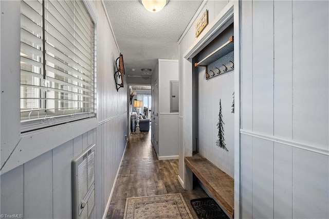 mudroom featuring a textured ceiling, electric panel, and dark hardwood / wood-style floors