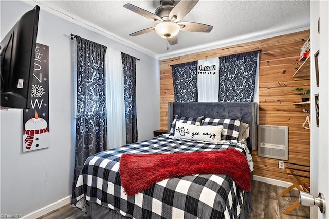 bedroom featuring dark wood-type flooring, an AC wall unit, a textured ceiling, wooden walls, and ceiling fan