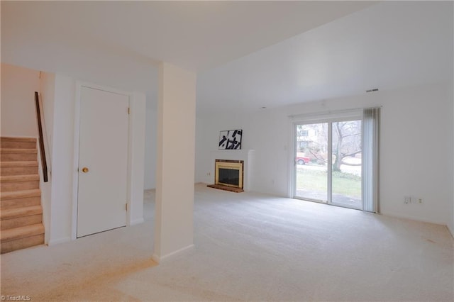 unfurnished living room with light colored carpet