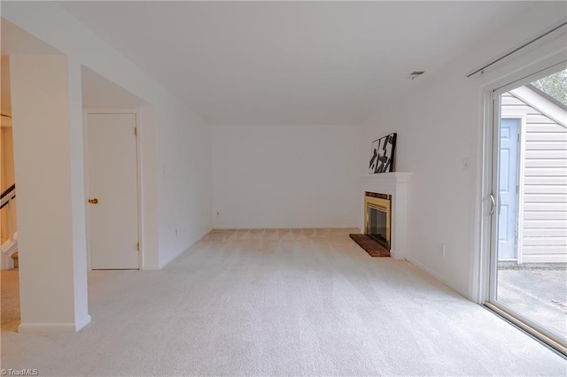 unfurnished living room with light colored carpet