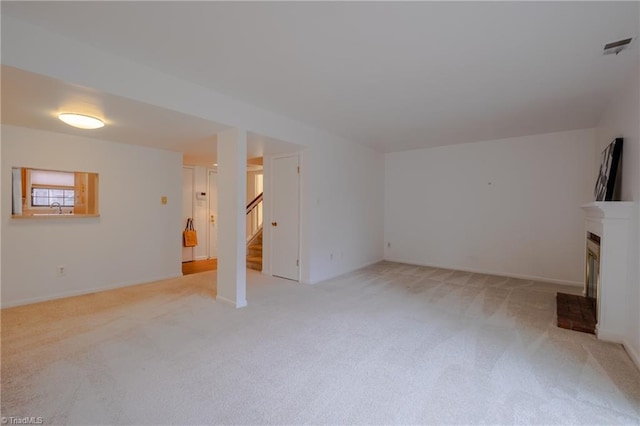 unfurnished living room with sink and light carpet