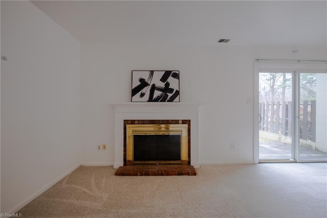 unfurnished living room featuring a brick fireplace and carpet