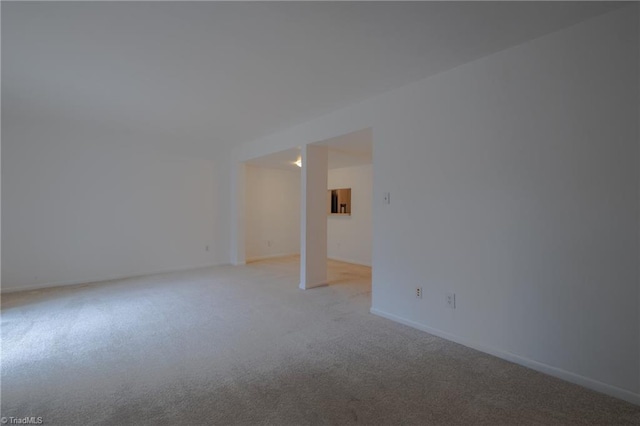 unfurnished room with light colored carpet