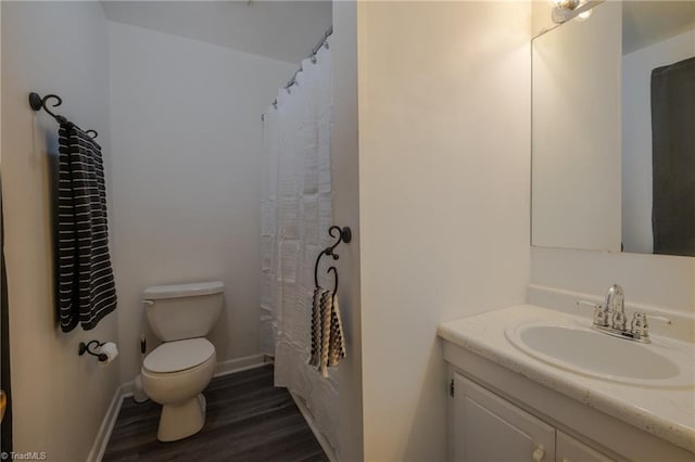 bathroom featuring hardwood / wood-style flooring, vanity, and toilet