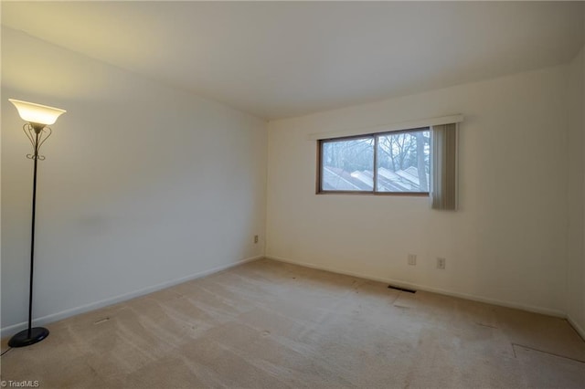 empty room with light colored carpet