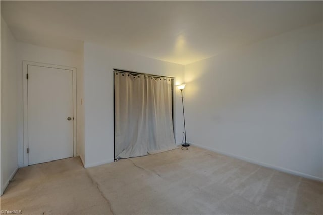 unfurnished bedroom featuring light carpet