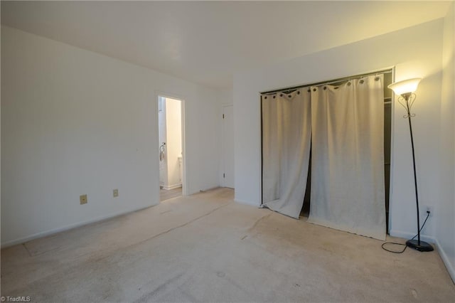 unfurnished bedroom featuring light colored carpet