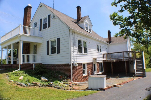 2289 W Pine St, Mount Airy, NC 27030 - view of side of home with stairway, a chimney, a balcony, and a deck
