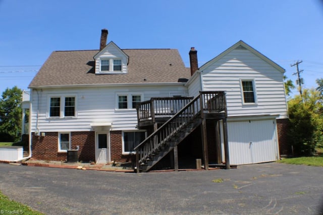 2289 W Pine St, Mount Airy, NC 27030 - back of property featuring a wooden deck, stairway, central AC unit, brick siding, and a chimney