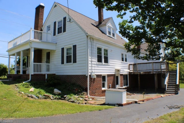 2289 W Pine St, Mount Airy, NC 27030 - view of property exterior with stairway, a chimney, a balcony, and a yard