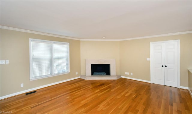 unfurnished living room with crown molding and hardwood / wood-style floors