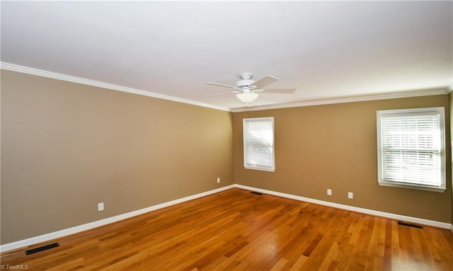 empty room with crown molding, hardwood / wood-style flooring, and ceiling fan