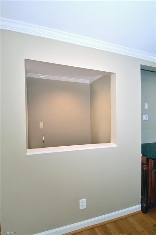 hall with crown molding and hardwood / wood-style floors