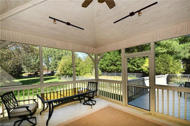 sunroom featuring ceiling fan and a healthy amount of sunlight