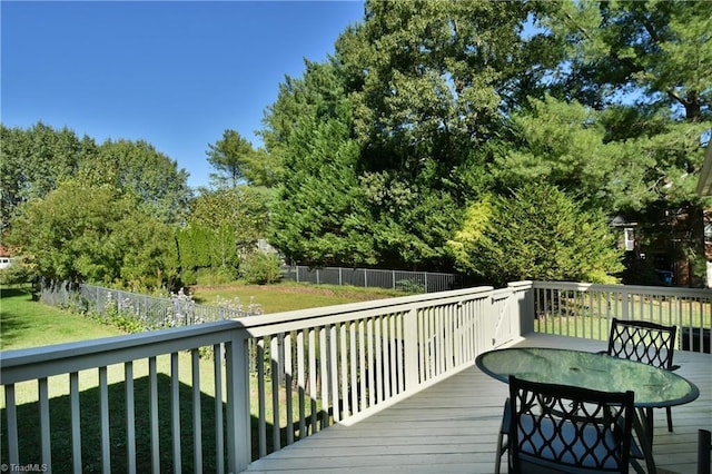 wooden deck featuring a lawn