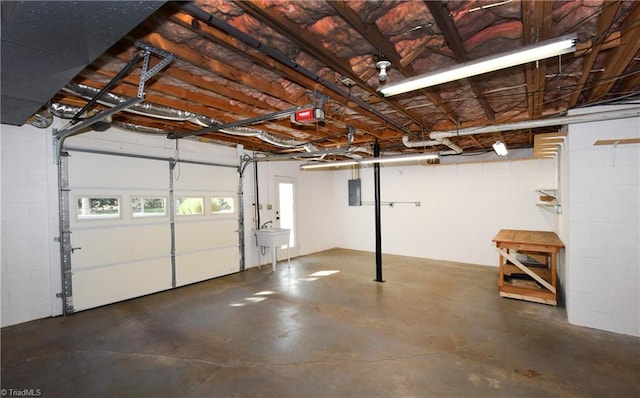 garage featuring electric panel and sink