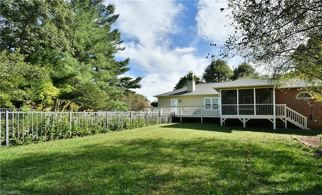 view of yard featuring a deck and a sunroom