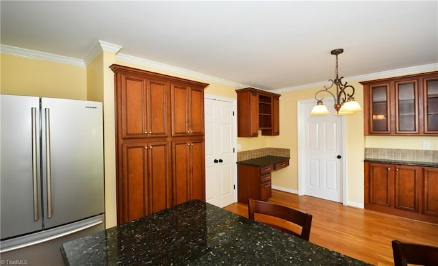 kitchen featuring stainless steel fridge, decorative light fixtures, a chandelier, hardwood / wood-style flooring, and crown molding