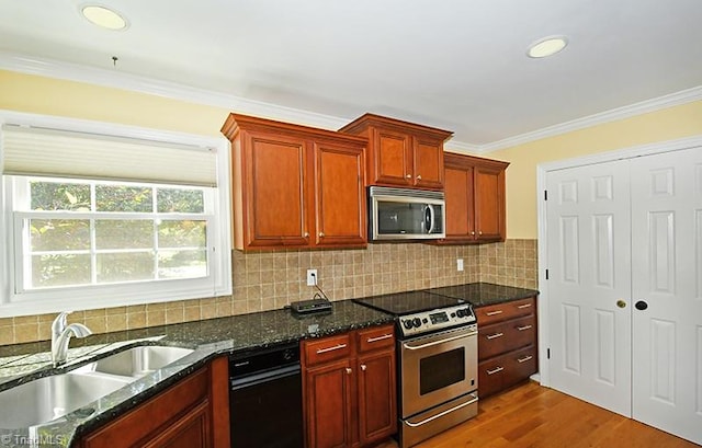 kitchen featuring hardwood / wood-style flooring, sink, crown molding, appliances with stainless steel finishes, and backsplash