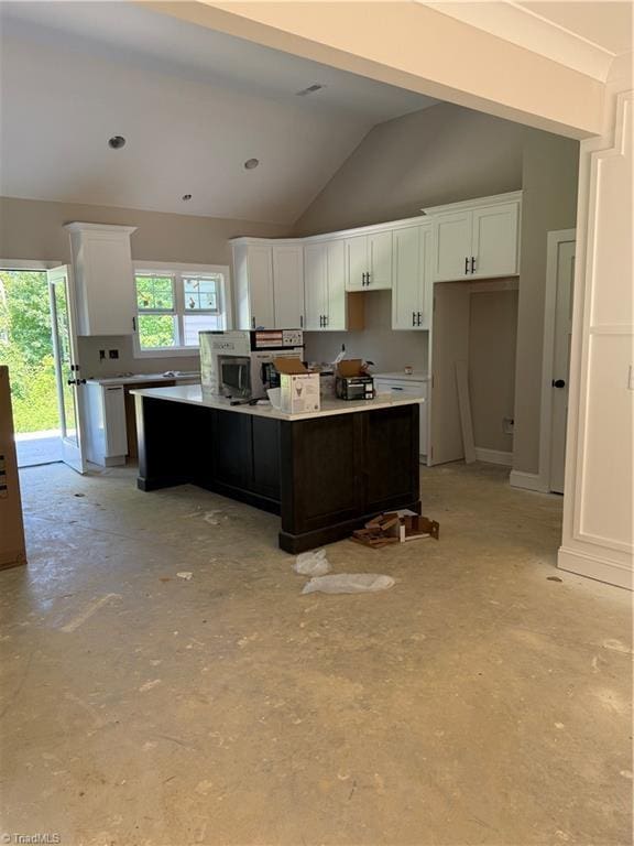2566 NC Highway 801 S, Advance, NC 27006 - kitchen featuring a kitchen island, white cabinetry, lofted ceiling, concrete floors, and light countertops