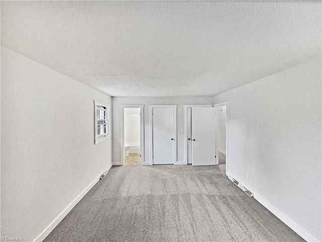 115 Wills Rd, Advance, NC 27006 - unfurnished bedroom with carpet floors, baseboards, a textured ceiling, and ensuite bathroom