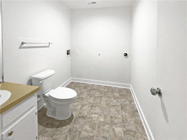 115 Wills Rd, Advance, NC 27006 - bathroom featuring vanity, toilet, and baseboards