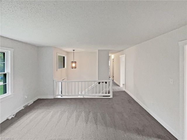 115 Wills Rd, Advance, NC 27006 - empty room featuring carpet flooring, a textured ceiling, baseboards, and a chandelier