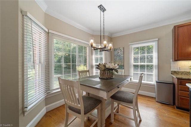 6303 Reata Ct, Summerfield, NC 27358 - dining space with a chandelier, light wood finished floors, and crown molding