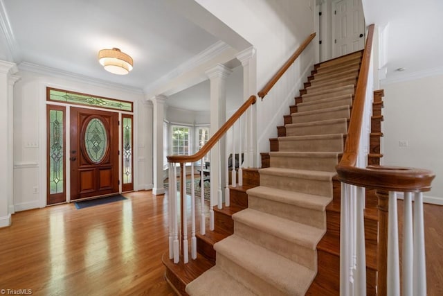 6303 Reata Ct, Summerfield, NC 27358 - entryway with ornate columns, crown molding, light wood-style flooring, and stairway