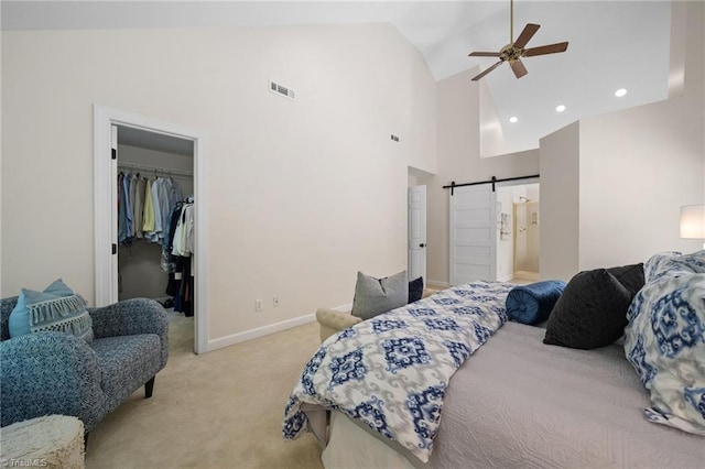6303 Reata Ct, Summerfield, NC 27358 - bedroom featuring a barn door, light colored carpet, a spacious closet, high vaulted ceiling, and a closet