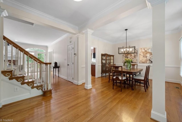 6303 Reata Ct, Summerfield, NC 27358 - entrance foyer with decorative columns, light wood-style floors, stairs, ornamental molding, and a chandelier