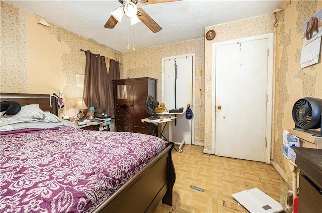 bedroom featuring a ceiling fan and wallpapered walls