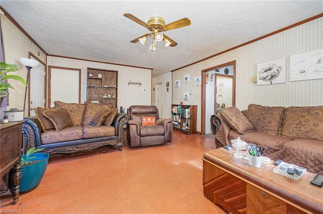 living area featuring wallpapered walls, ornamental molding, a ceiling fan, a textured ceiling, and tile patterned floors