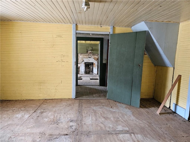 unfurnished room featuring lofted ceiling and wood ceiling